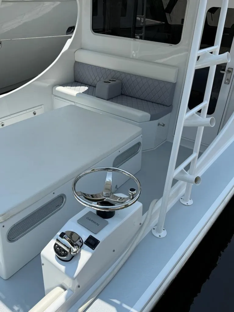 Slide: The Image of 2004 Mabry 40 boat interior with steering wheel, seating, and control panel. - 17
