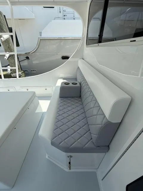 Slide: The Image of Luxurious seating area on a 2004 Mabry 40 boat with quilted upholstery and cup holders. - 20