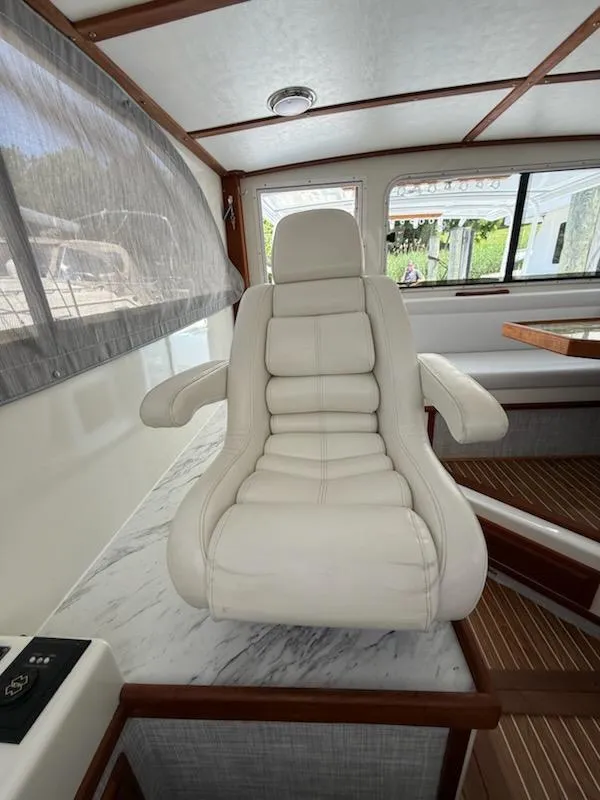 Slide: The Image of Luxurious white captain's chair in a 2004 Mabry 40 boat interior. - 22