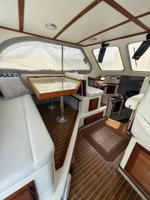 Slide: The Image of Interior of a 2004 Mabry 40 boat with wooden accents and seating area. - 24