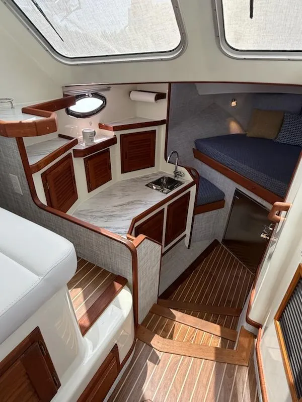 Slide: The Image of Interior of a 2004 Mabry 40 boat with wood accents and compact kitchen. - 29