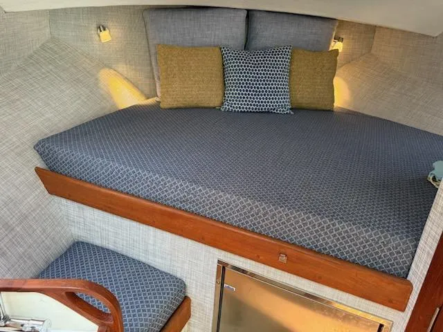 Slide: The Image of Cozy cabin interior of 2004 Mabry 40 boat with patterned bedding and cushions. - 31