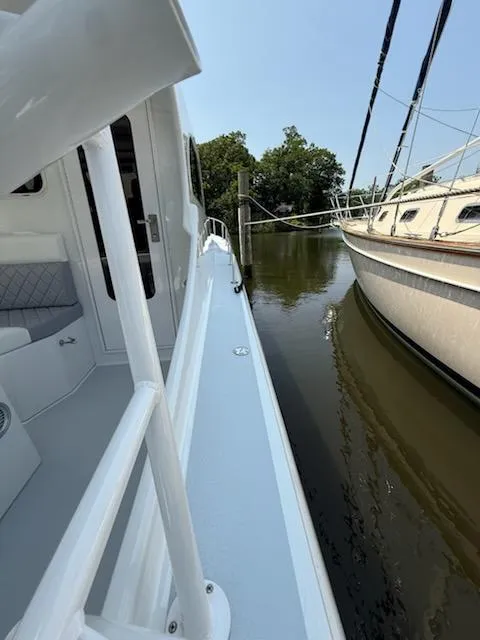 Slide: The Image of 2004 Mabry 40 boat docked beside another vessel on calm water. - 8