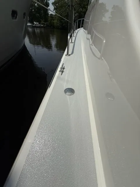 Slide: The Image of Side view of a 2004 Mabry 40 boat docked near water. - 9