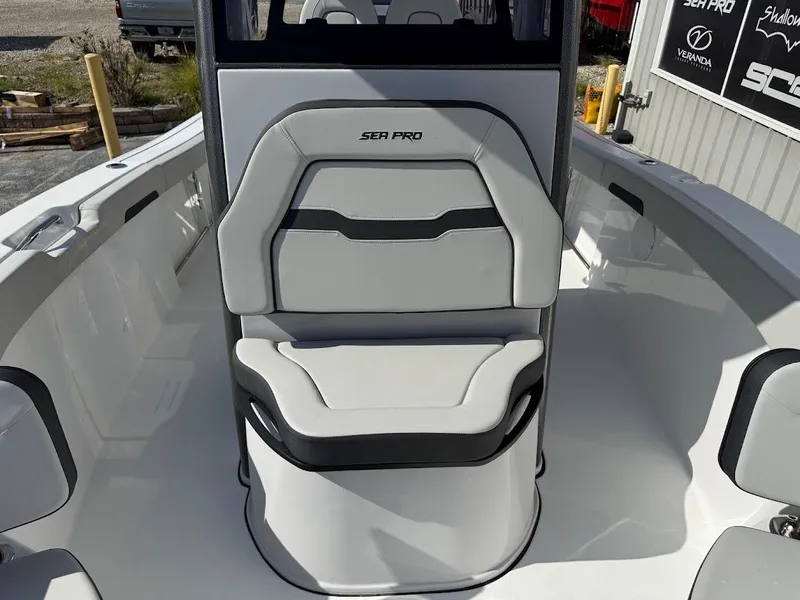 Slide: The Image of 2025 Sea Pro 242 Center Console boat interior with cushioned seating. - 11