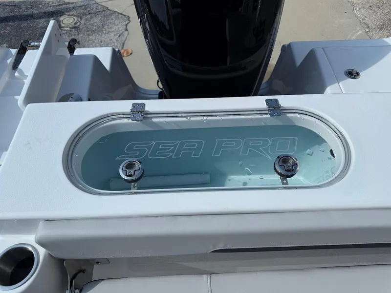 Slide: The Image of 2025 Sea Pro 242 Center Console livewell with clear lid and branding. - 15