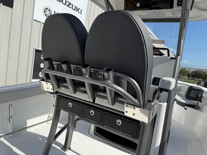 Slide: The Image of 2025 Sea Pro 242 Center Console boat interior with dual seats and rod holders. - 18