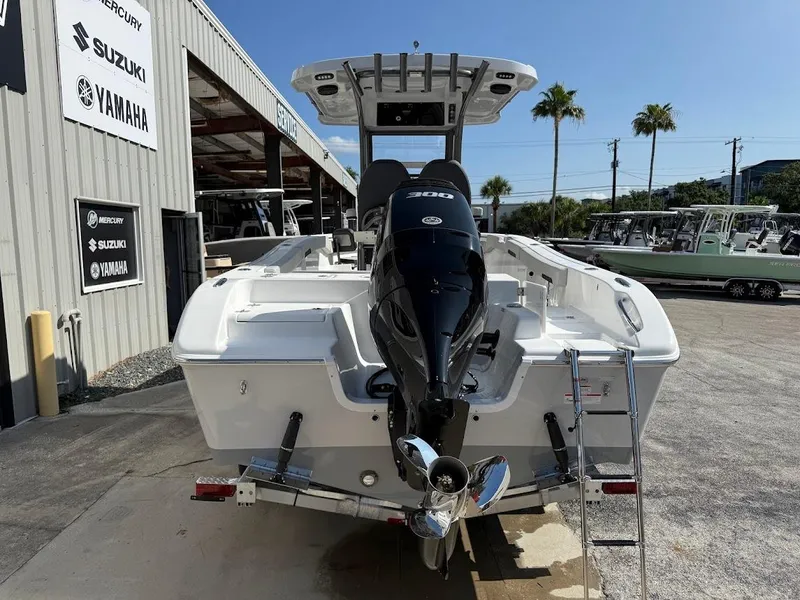 Slide: The Image of 2025 Sea Pro 242 Center Console boat with powerful outboard motor, parked at dealership. - 8
