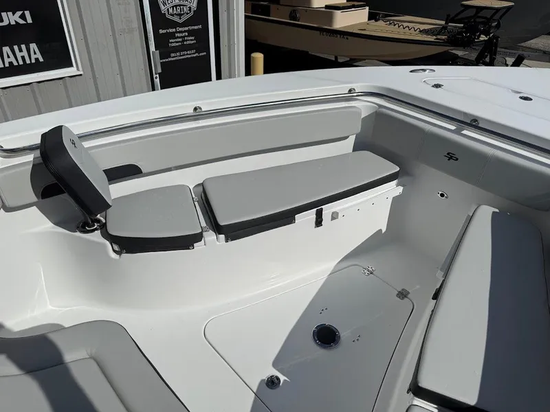 Slide: The Image of 2025 Sea Pro 242 Center Console boat interior with gray seating and storage compartments. - 9