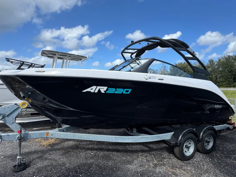 The Image of 2025 Yamaha Boats AR220 on trailer under blue sky. - 0