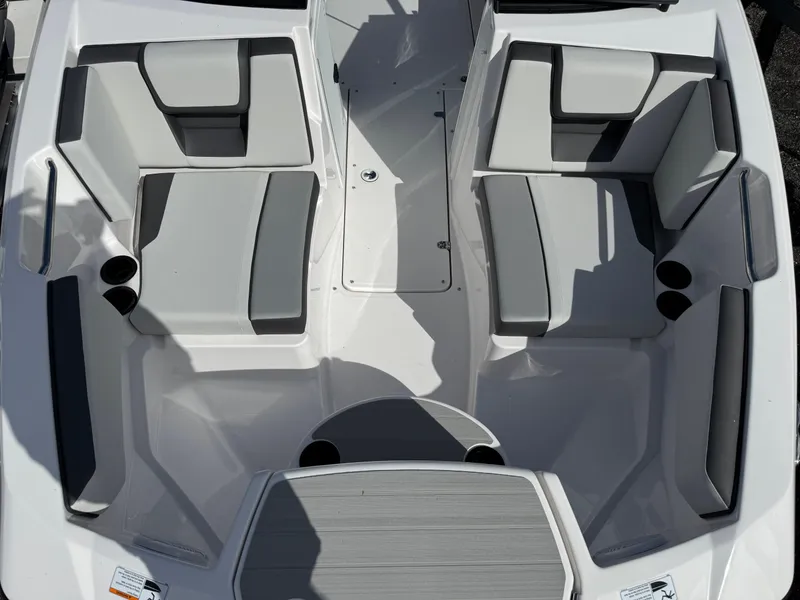 Slide: The Image of 2025 Yamaha Boats AR220 interior seating layout with gray and white upholstery. - 14