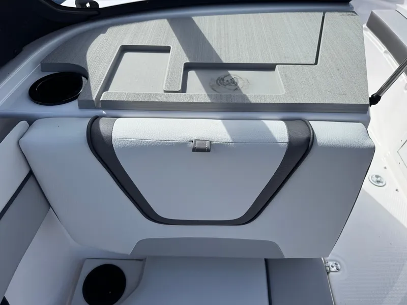 Slide: The Image of 2025 Yamaha Boats AR220 interior detail with cup holders and storage compartment. - 16