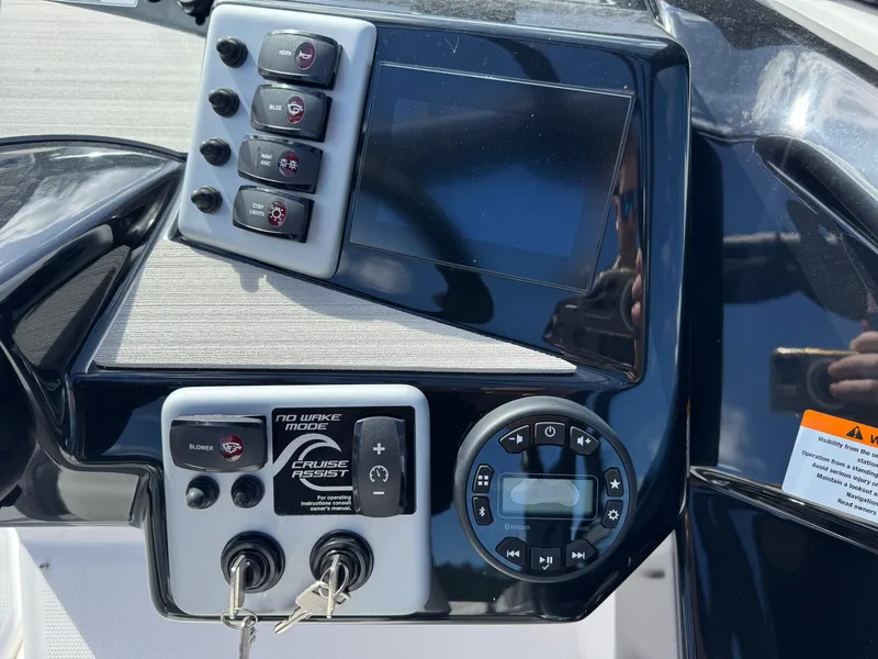 Slide: The Image of Control panel of 2025 Yamaha Boats AR220 with touchscreen and key ignition. - 22