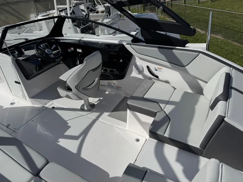 Slide: The Image of 2025 Yamaha Boats AR220 interior with sleek seating and modern dashboard design. - 6