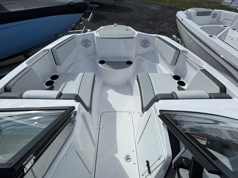 Slide: The Image of 2025 Yamaha Boats AR220 interior with spacious seating and cup holders. - 7