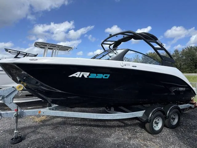 The Image of 2025 Yamaha Boats AR220 on trailer under blue sky. - 1