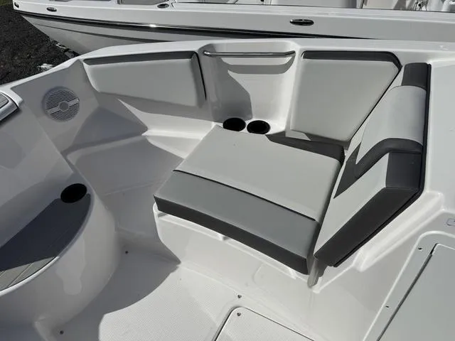 Slide: The Image of 2025 Yamaha Boats AR220 interior seating with cup holders and sleek design. - 10