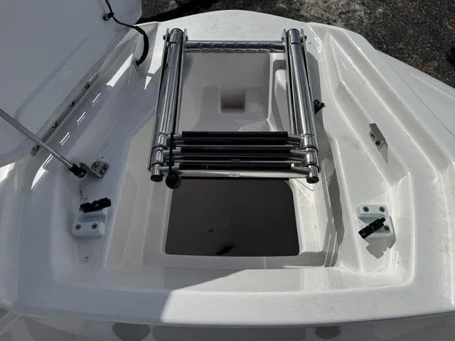 Slide: The Image of 2025 Yamaha Boats AR220 bow with stainless steel ladder and storage compartment. - 13