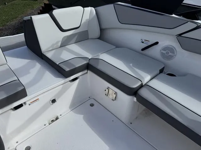 Slide: The Image of 2025 Yamaha AR220 boat interior with gray seating and speaker. - 18