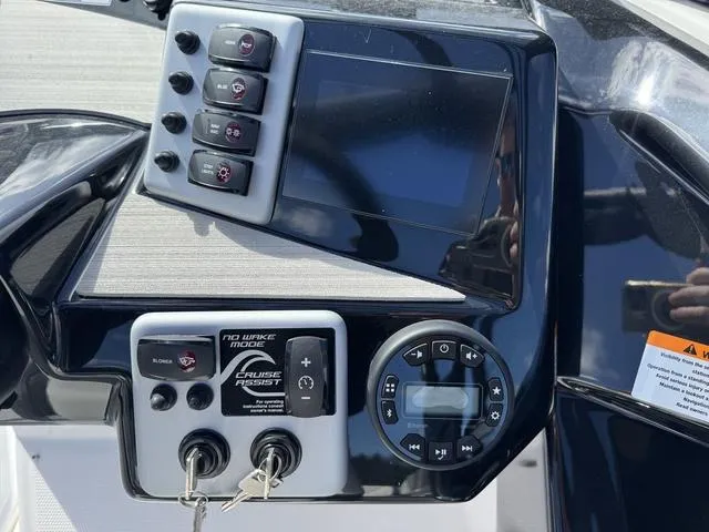 Slide: The Image of Control panel of 2025 Yamaha Boats AR220 with digital display and key switches. - 22