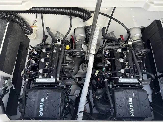 Slide: The Image of 2025 Yamaha AR220 boat engine compartment with dual engines and wiring. - 24