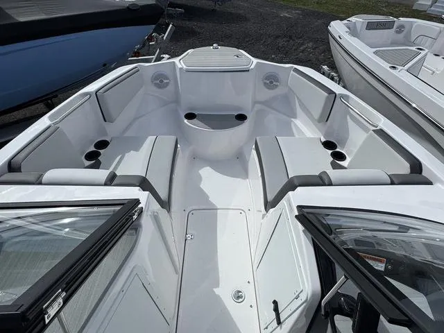 Slide: The Image of 2025 Yamaha Boats AR220 interior with spacious seating and cup holders. - 8