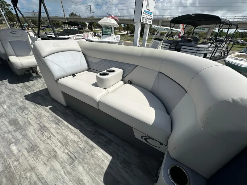 Slide: The Image of 2022 Crest Classic DLX 220 boat interior with plush seating and cup holders. - 14
