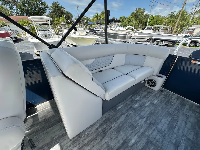 Slide: The Image of 2022 Crest Classic DLX 220 boat interior with white seating and modern design. - 21