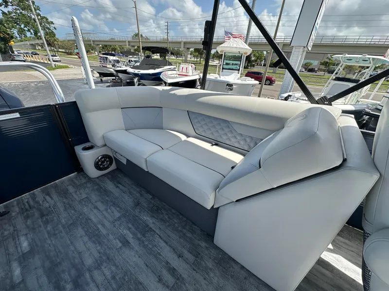 Slide: The Image of 2022 Crest Classic DLX 220 boat interior with plush seating and modern design. - 22