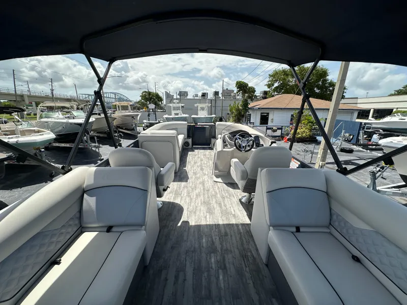 Slide: The Image of 2022 Crest Classic DLX 220 pontoon boat interior with spacious seating and modern design. - 23