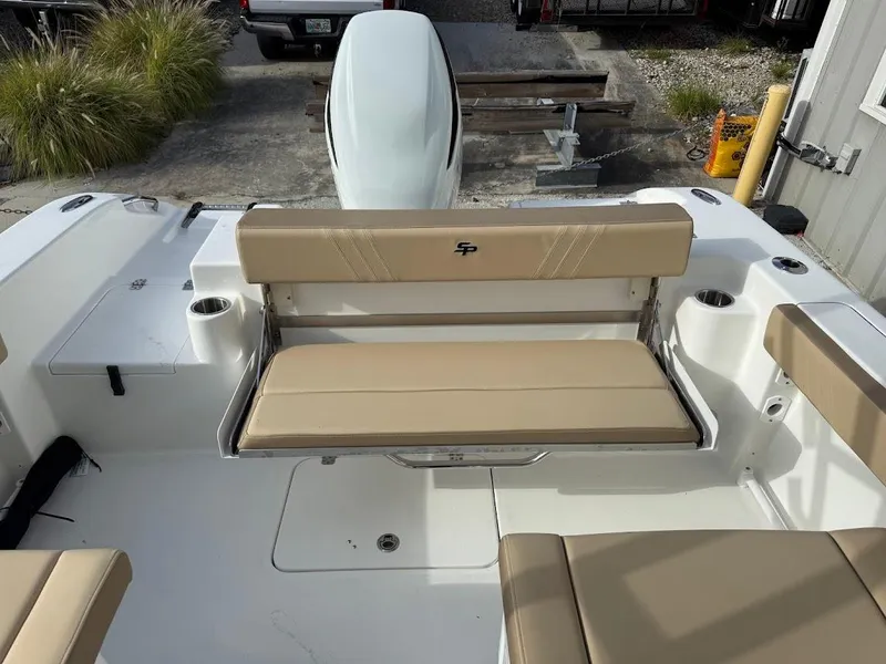 Slide: The Image of 2025 Sea Pro 240 Dual Console boat interior with beige seating and cup holders. - 10