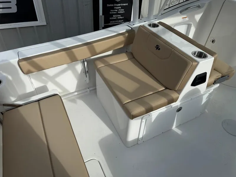 Slide: The Image of 2025 Sea Pro 240 Dual Console boat interior with beige seating and cup holders. - 12
