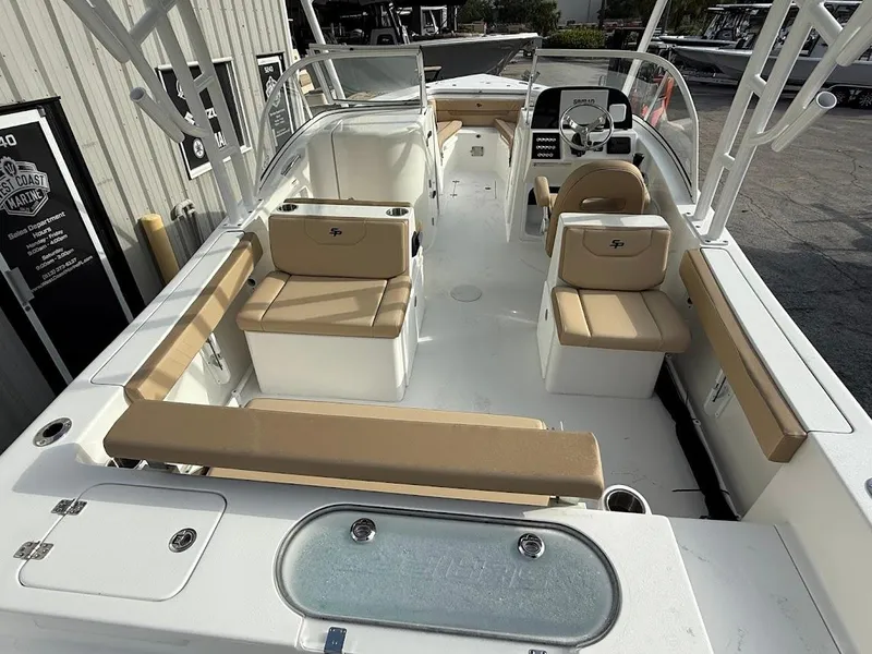 Slide: The Image of 2025 Sea Pro 240 Dual Console boat with beige seating and modern dashboard. - 13