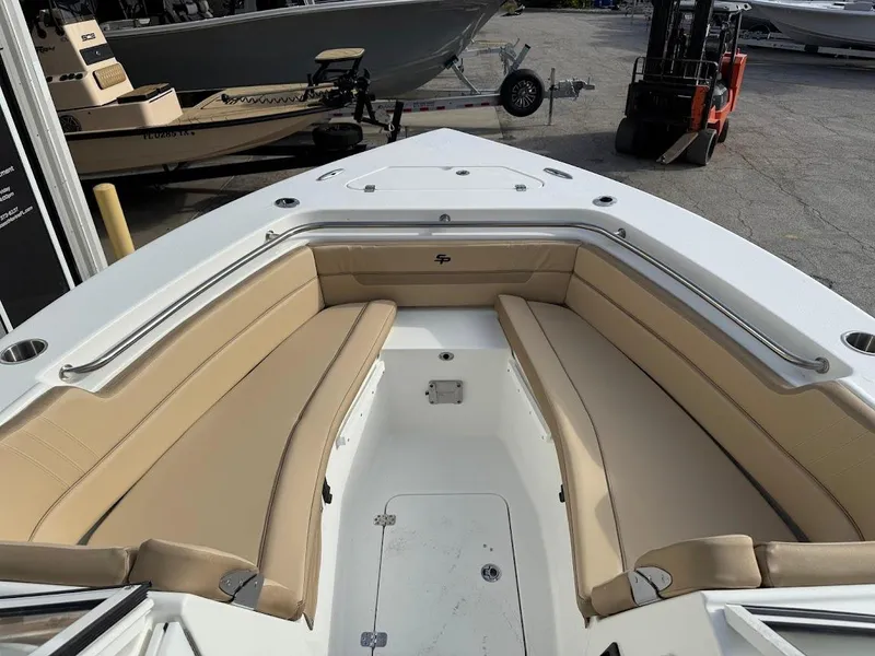 Slide: The Image of 2025 Sea Pro 240 Dual Console boat with tan seating and spacious deck. - 15