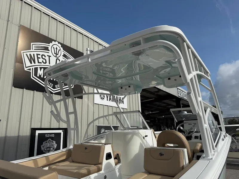 Slide: The Image of 2025 Sea Pro 240 Dual Console boat with beige seating, displayed at West Coast Marine. - 5
