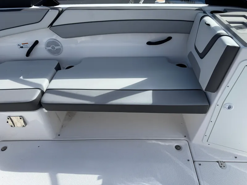 Slide: The Image of 2025 Yamaha Boats AR220 interior seating with gray cushions and sleek design. - 16