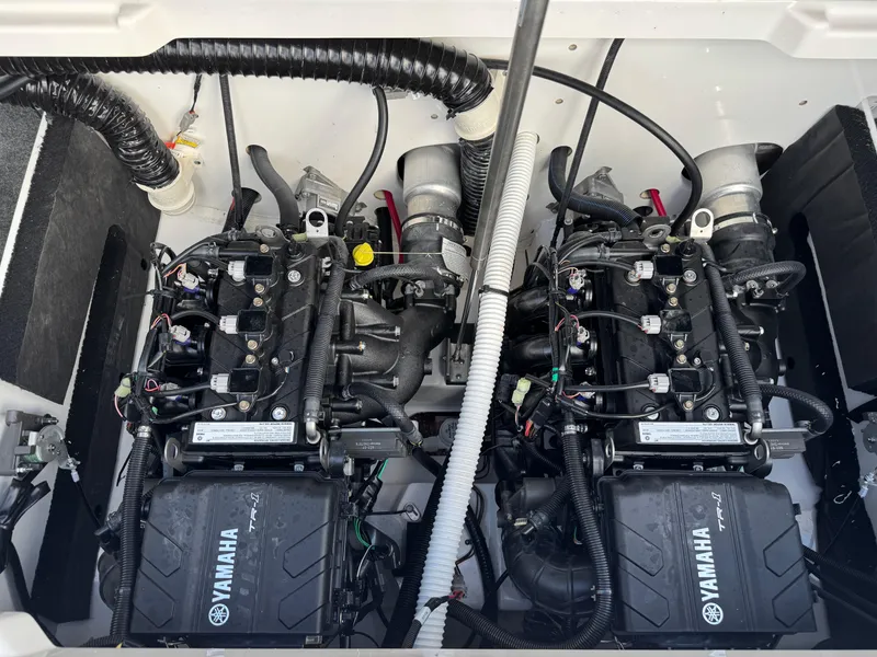 Slide: The Image of 2025 Yamaha AR220 boat engine compartment with dual engines and wiring. - 23