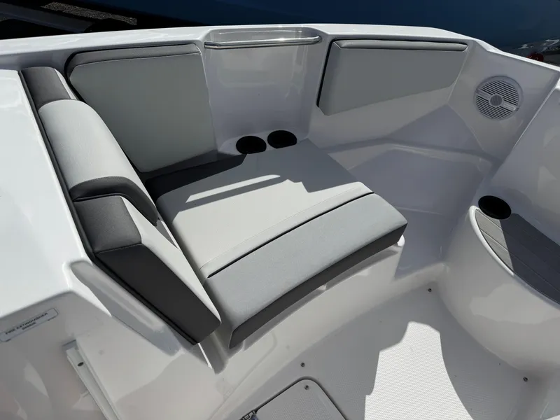 Slide: The Image of 2025 Yamaha Boats AR220 interior seating with cup holders and speaker. - 8