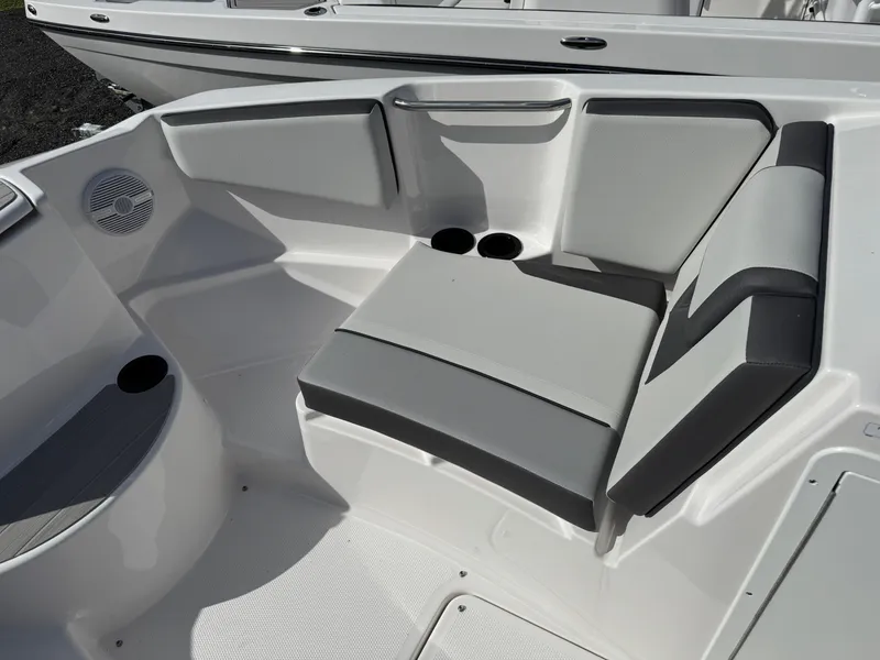 Slide: The Image of 2025 Yamaha Boats AR220 interior seating with cup holders and speaker. - 9