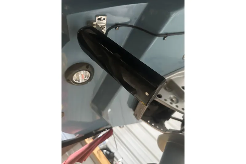 Slide: The Image of Close-up of a 2021 Sea Cat 260 boat component, featuring a black fixture and wiring. - 15