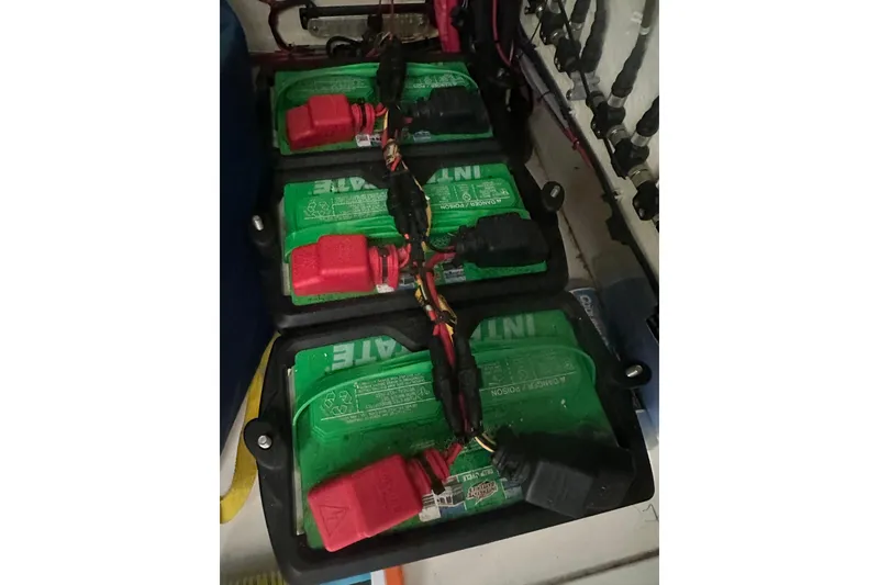 Slide: The Image of Batteries in a 2021 Sea Cat 260 boat, connected with red and black cables. - 18