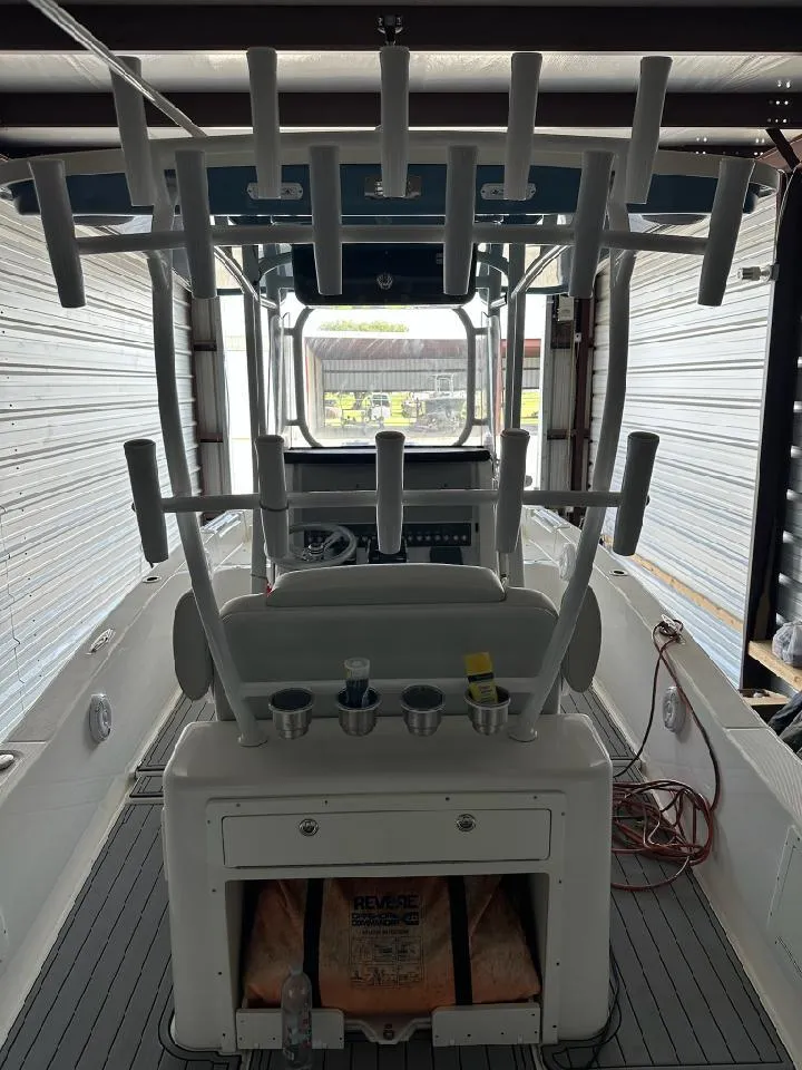 Slide: The Image of 2021 Sea Cat 260 boat interior with rod holders and storage compartments. - 4