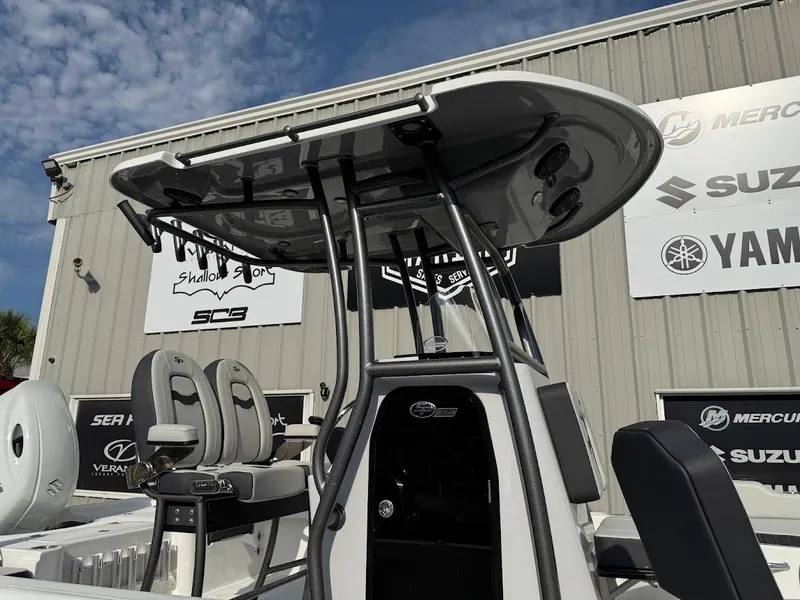 Slide: The Image of 2025 Sea Pro 230 Bay boat with T-top, displayed outside dealership with brand logos. - 3