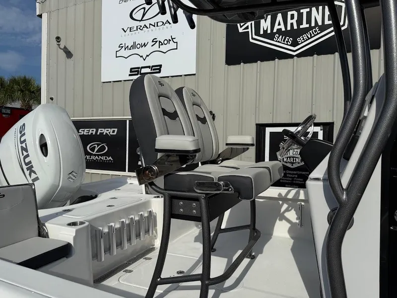 Slide: The Image of 2025 Sea Pro 230 Bay boat interior with Suzuki engine, displayed at a marine sales service. - 4
