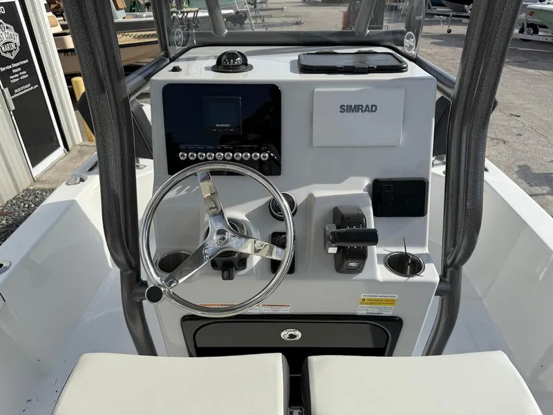 Slide: The Image of 2025 Sea Pro 230 Bay boat console with steering wheel and Simrad electronics. - 9