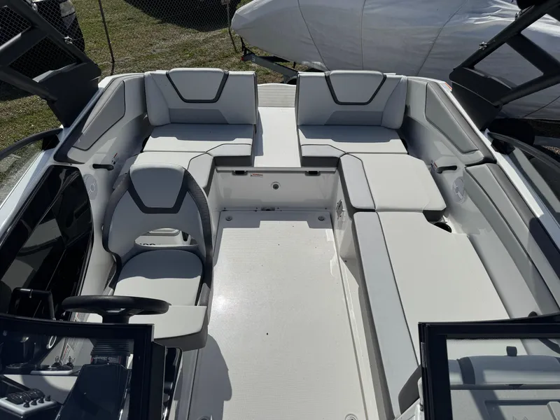 Slide: The Image of 2025 Yamaha Boats AR220 interior with spacious seating and modern design. - 12