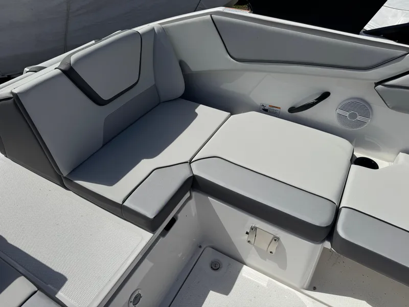 Slide: The Image of 2025 Yamaha AR220 boat interior with gray cushioned seating and speaker. - 16