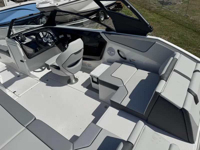 Slide: The Image of 2025 Yamaha Boats AR220 interior with modern seating and sleek dashboard design. - 5