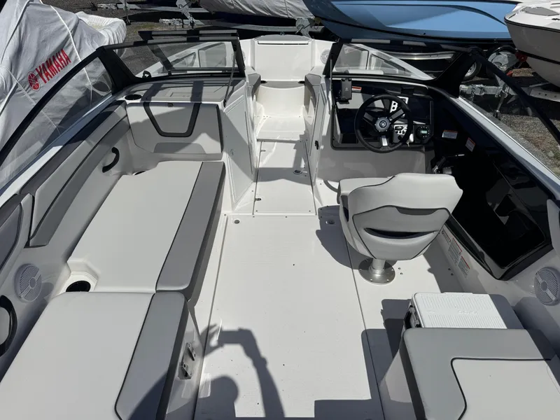 Slide: The Image of 2025 Yamaha Boats AR220 interior with sleek seating and modern dashboard design. - 6