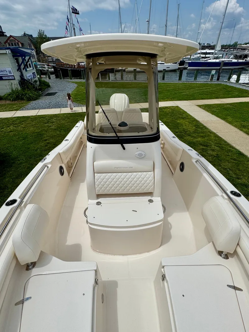Slide: The Image of 2025 Grady-White Fisherman 216 boat docked, showcasing spacious seating and sleek design. - 10